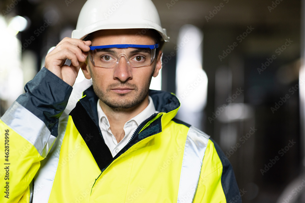 Portrait of Professional Engineer or Worker Wearing Safety Uniform and Hard Hat. Ecology worker Industrial people. Sustainable energy. Technology Portrait of Professional Engineer or Worker Wearing Safety Uniform and Hard Hat. Ecology worker Industrial people. Sustainable energy. Technology