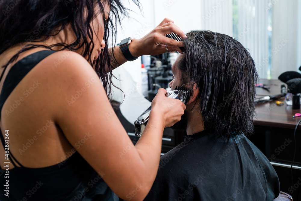 Fototapeta premium master hairdresser does hairstyle and style with scissors and comb, Barber shop