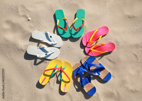 Stylish flip flops on beach, flat lay
