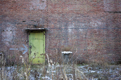 An iron door in a brick wall.