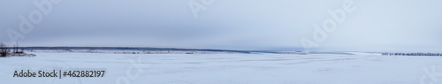Panorama Winter view of a snow-covered plain or steppe in cloudy weather