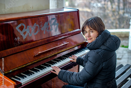 woman playing piano outdoors on autumn day