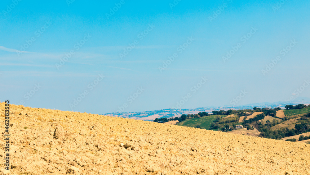Countryside landscape in summer day, view of plowed fields