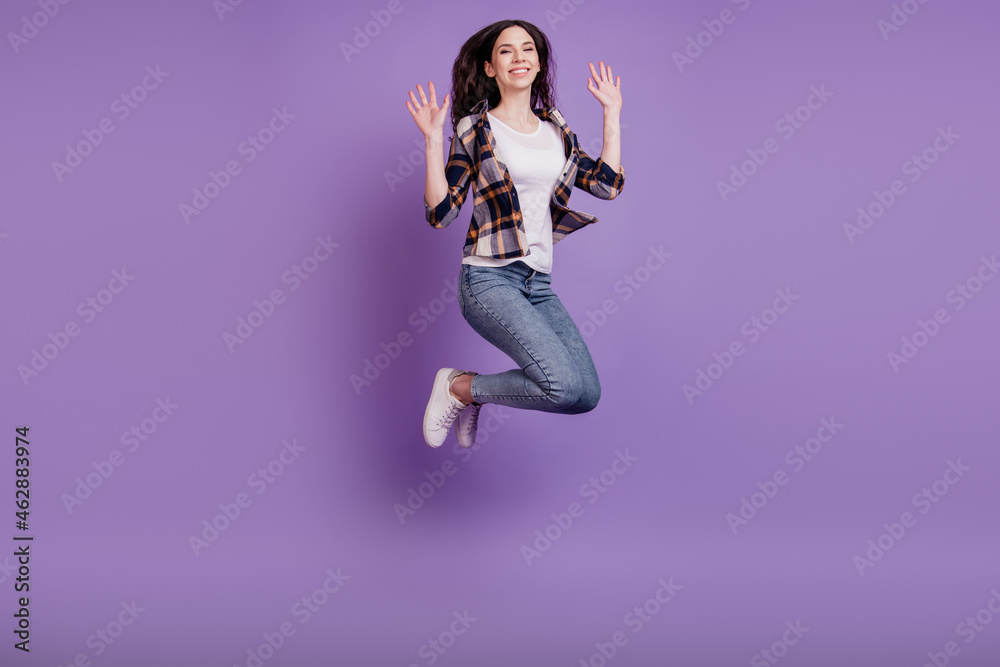 Full length photo of young crazy girl happy positive smile jump up fly air isolated over violet color background