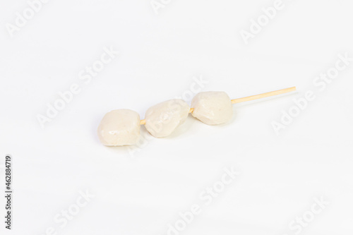 Fish balls on skewers on a white background