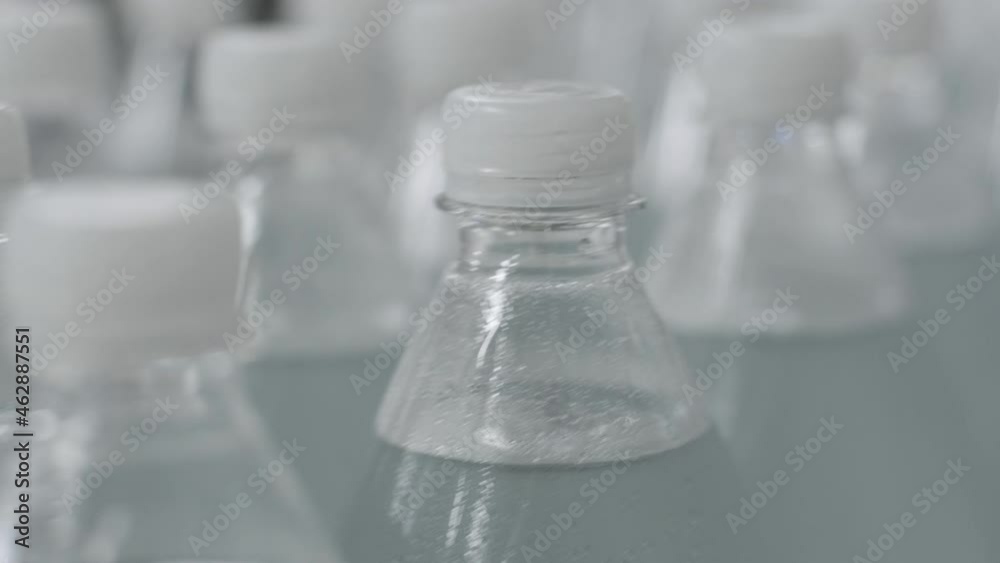 Conveyor belt with bottles of drinking water at a modern beverage plant Conveyor belt with bottles of drinking water at a modern beverage plant