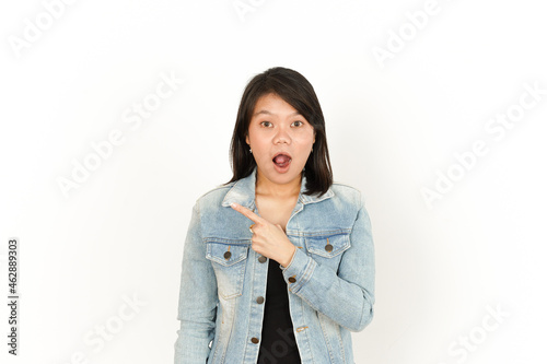 Showing and Pointing Left Side of Beautiful Asian Woman Wearing Jeans Jacket and black shirt Isolated On White Background