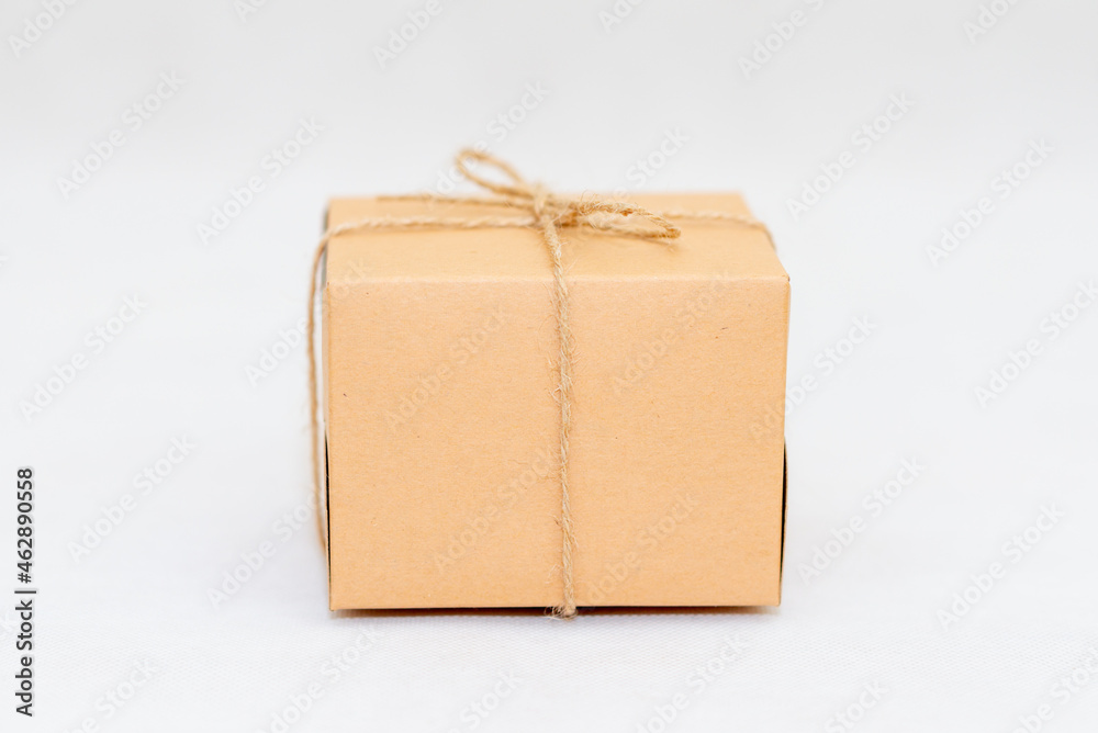 Holiday card. Beige gift box on white background. Flat lay,copy space. Holiday card. Beige gift box on white background. Flat lay,copy space.