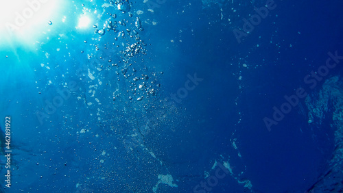 View of Air Bubbles underwater. Blue water and sun. Adriatic Sea	