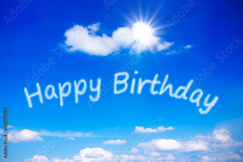 Canvas Print Happy Birthday written on a sunny blue sky, symbol for best wishes for a carefree special day with endless sun