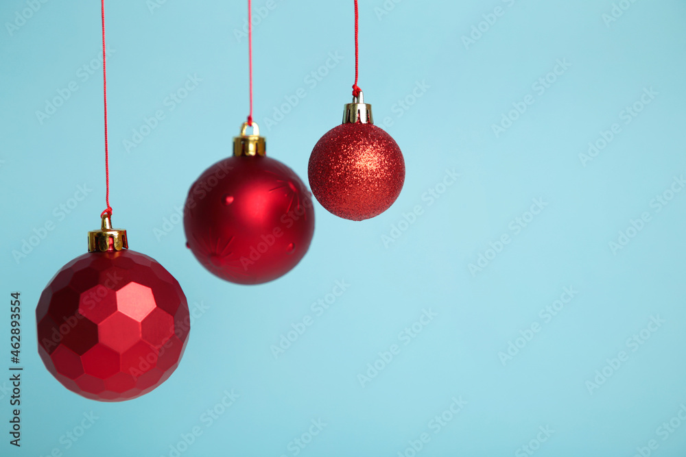 Red Christmas balls on blue background. New Year concept. Red Christmas balls on blue background. New Year concept.