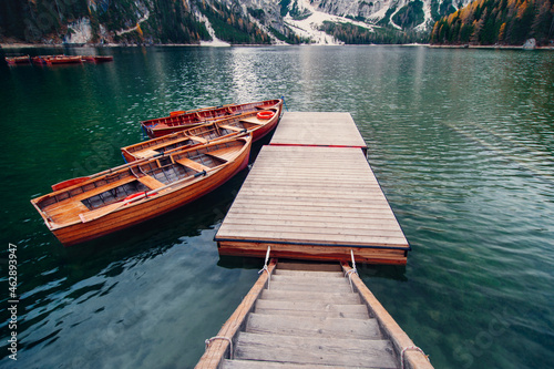 Amazing view of lake Lago di Braies in Dolomiti mountains. famous old wooden rowing boats on lake. South Tyrol, Italy.