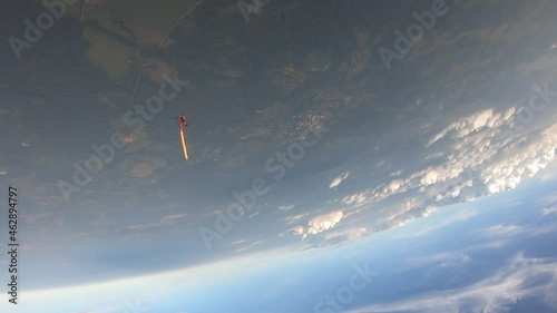 Skydiving. A fun jump. Headdown freefly.  Skydiver falls with a tube on her leg.