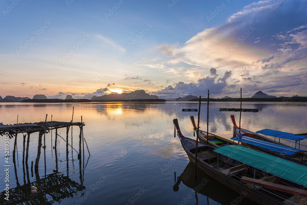 Ban Sam Chong Tai and colorful sunrises that emerges behind the giant limestone mountains, Thailand Ban Sam Chong Tai and colorful sunrises that emerges behind the giant limestone mountains, Thailand