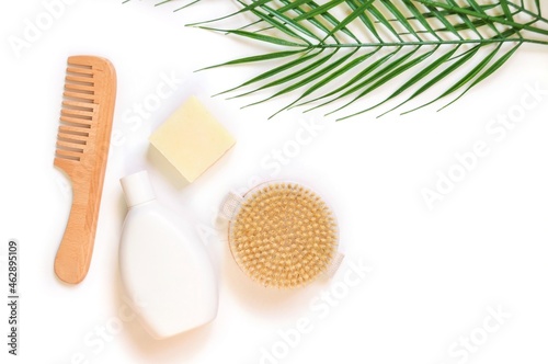 Natural organic bath products for hair and body care. White shampoo bottle  soap  brush for dry massage and wooden comb. Flat lay photography for website design or beauty blog