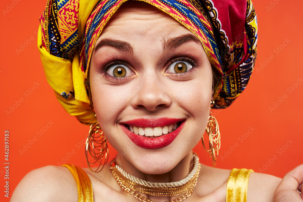 cheerful woman in multicolored turban attractive look Jewelry red background