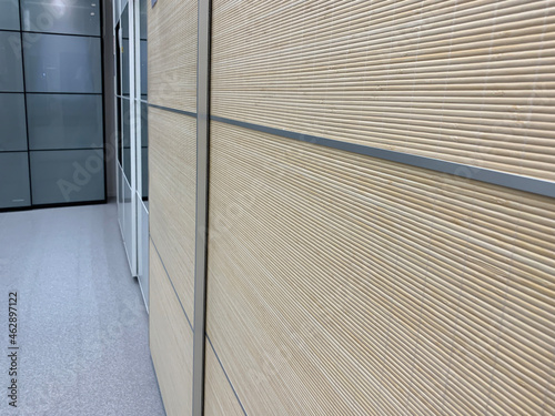 Sliding doors of modern wardrobe, case compartment with brown wooden dood panels in a hallway of a house