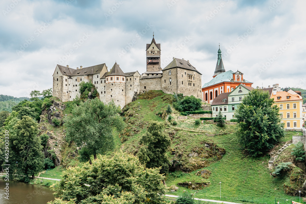 Panoramic view of famous medieval town of Loket,Elbogen, with colorful houses and stone castle above river,Czech Republic.Historical city centre is national monument.Travel architecture background.
