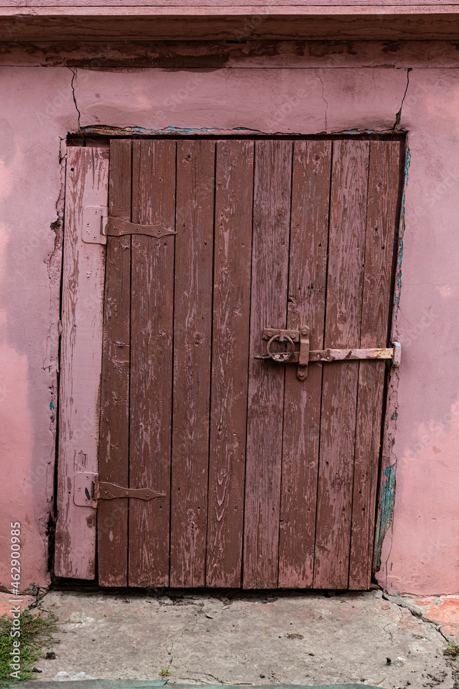 old wooden door leading to the cellar bolted old wooden door leading to the cellar bolted