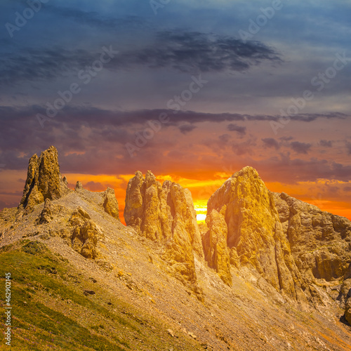 stony mountain chain at the sunset, dramatic travel background