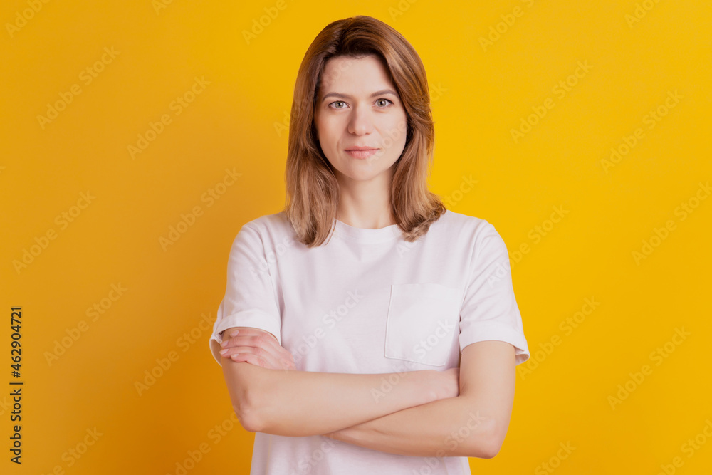 Photo of self-assured lady crossed hands wear casual outfit on yellow background Photo of self-assured lady crossed hands wear casual outfit on yellow background