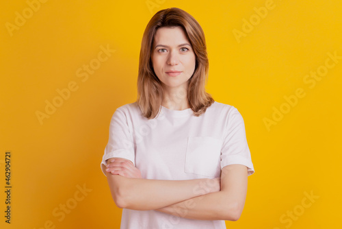 Photo of self-assured lady crossed hands wear casual outfit on yellow background