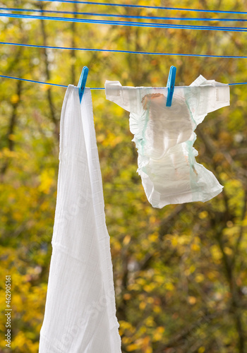 Baby diapers hanging on a clothesline