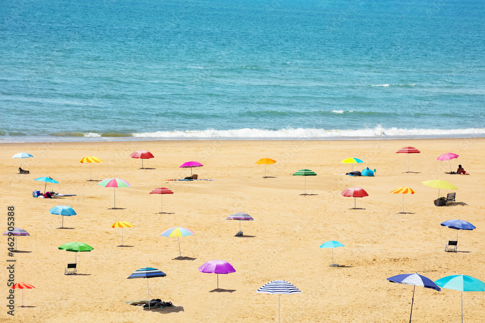 Many sunshade umbrellas on the sea beach resort