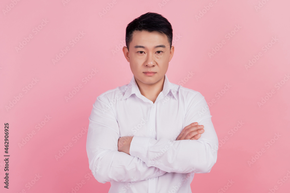 Photo of serious successful man folded arms look camera isolated pink color background Photo of serious successful man folded arms look camera isolated pink color background