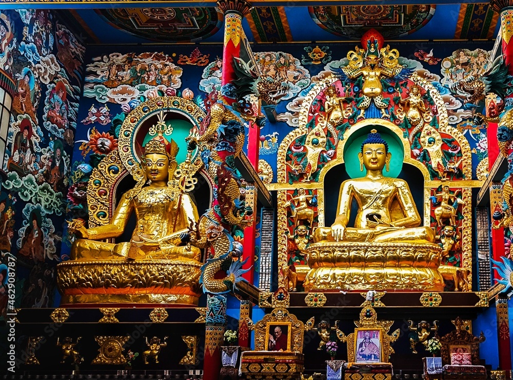 A beautiful shot of the interior of a Buddhist monastery in Coorg with golden statues