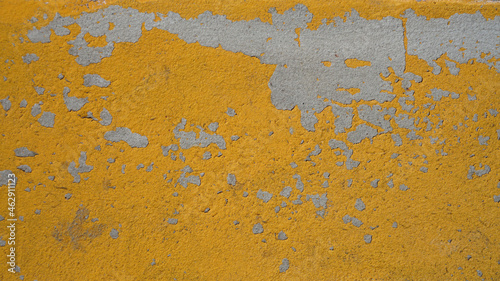 background texture stone wall painted with yellow paint, old scuffed surface vintage