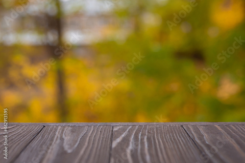inscription from letters autumn on a wooden background on a blurred gold background with bokeh