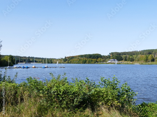 View of the first basin of the Sorpe Lake, North Rhine-Westphalia, Germany, on the left the small sailing boat harbor, in the background the first dam of the reservoir