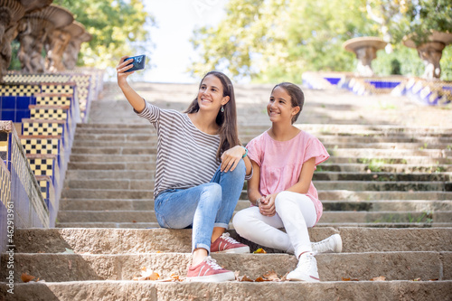 Canvas Print Girls taking a selfie on the park stairs
