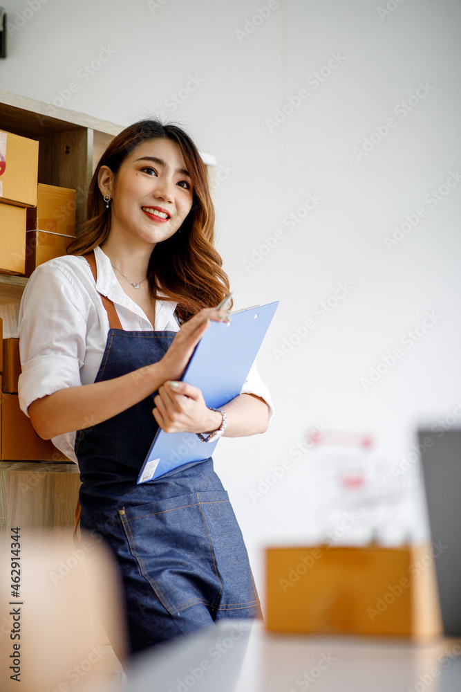 Portrait of Starting small businesses SME owners female entrepreneurs working on receipt box and check online orders to prepare to pack the boxes, sell to customers, sme business ideas online. Portrait of Starting small businesses SME owners female entrepreneurs working on receipt box and check online orders to prepare to pack the boxes, sell to customers, sme business ideas online.