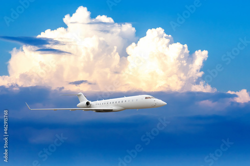 Business jet airplane flying on a high altitude above the clouds