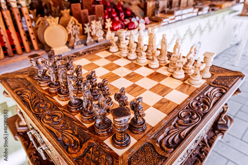 Vintage souvenir carved wooden chess in a craftsman shop
