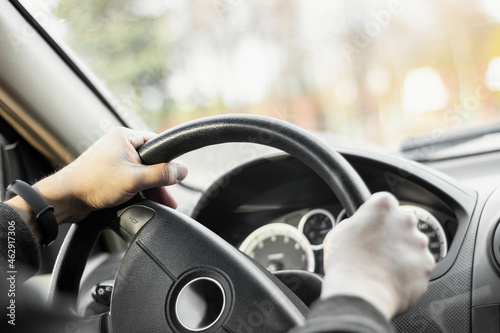Man holding steering wheel and driving his car © GraphiCore