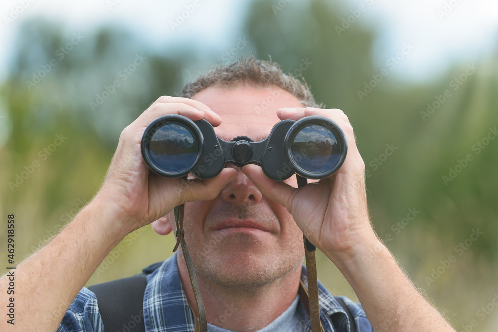 Man looking through binocular Man looking through binocular