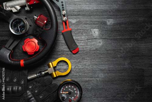 Car tuning equipment and accessories on the black table flat lay background.