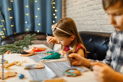 children decorate gingerbread homemade cookies by kids.  master-class. christmas activity