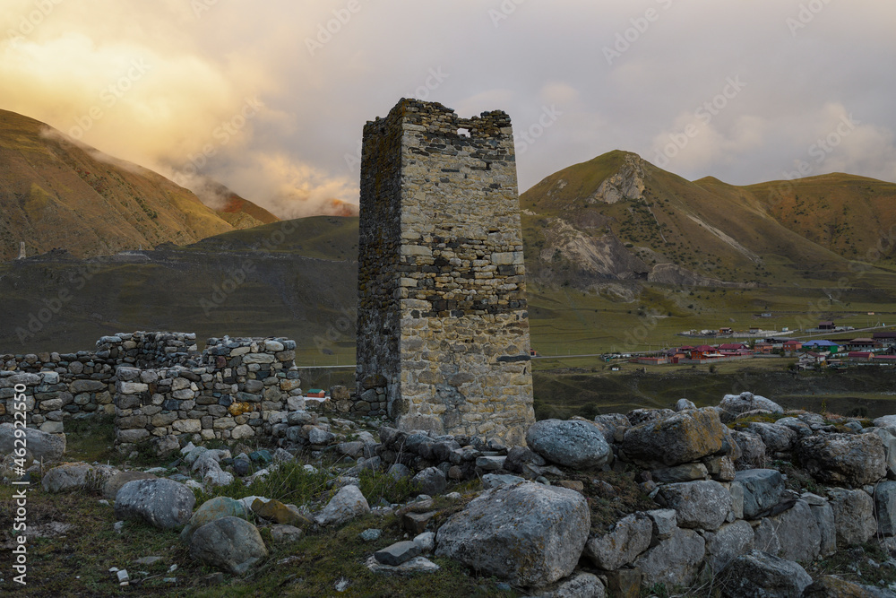 Ancient Ossetian defensive tower (Tsalikov Tower) on a September evening. The outskirts of the village of Dalagkau. North Ossetia, Russia