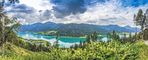 Panoramic view over turquoise lake Weissensee in Austrian province Carinthia during daytime © Aquarius