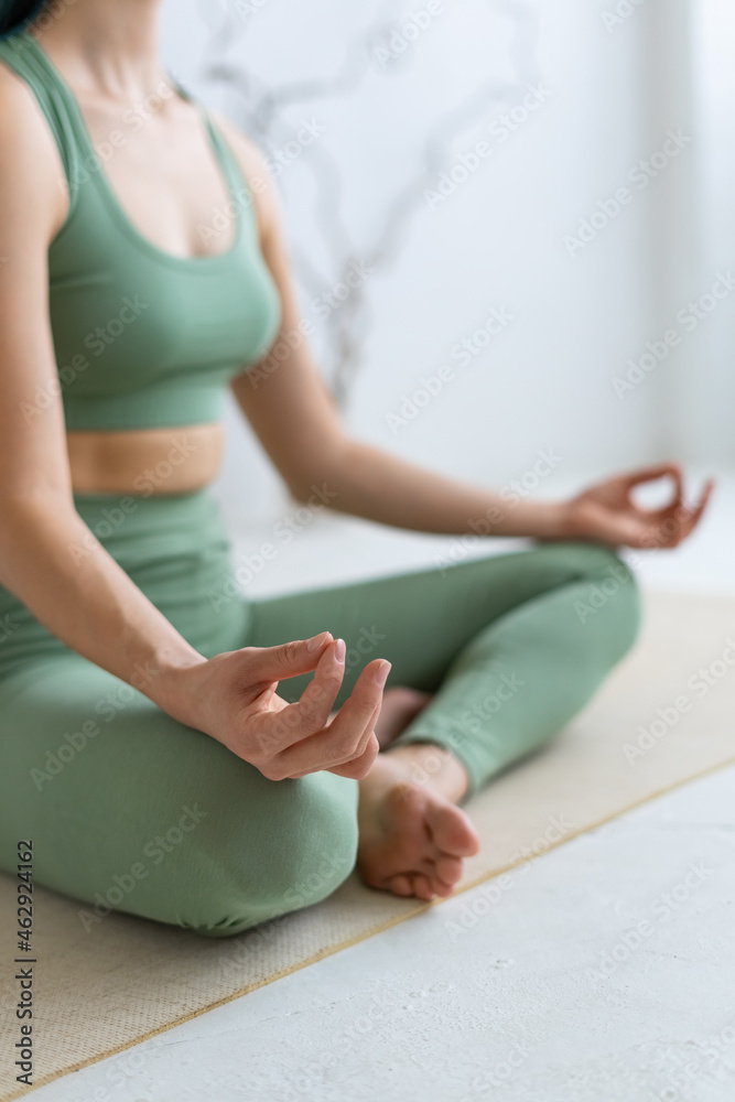 Woman in lotus position. Close-up of hand. Meditation and relaxation.