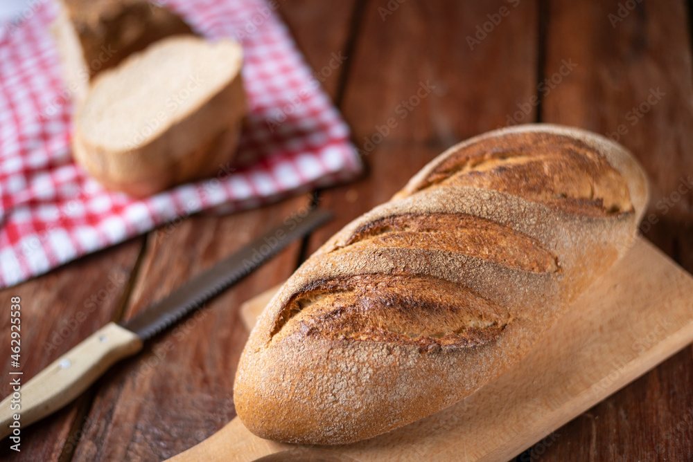 Freshly baked bread on old wooden background