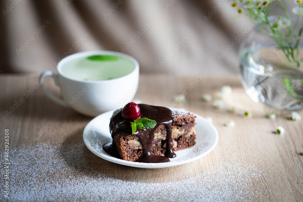 Still life with chocolate cake and cup of green tea Still life with chocolate cake and cup of green tea