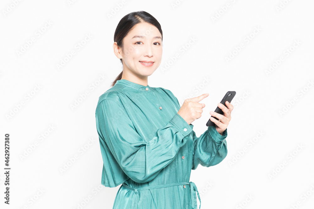 スマホを操作しながら笑っている主婦 スマホを操作しながら笑っている主婦