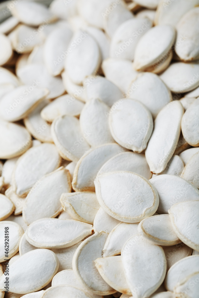 Pumpkin seeds in a shell as a textural background.