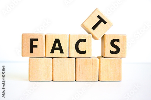 Facts symbol. The concept word 'facts' on wooden cubes. Beautiful white table, white background, copy space. Business, fact and facts concept.