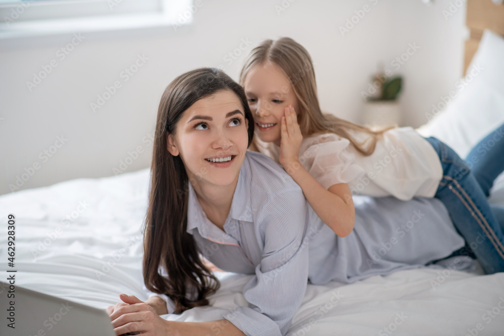 Mom and daughter spending time together and looking peaceful Mom and daughter spending time together and looking peaceful